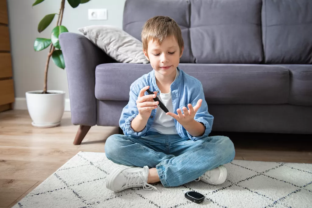 child_boy_measuring_blood_sugar